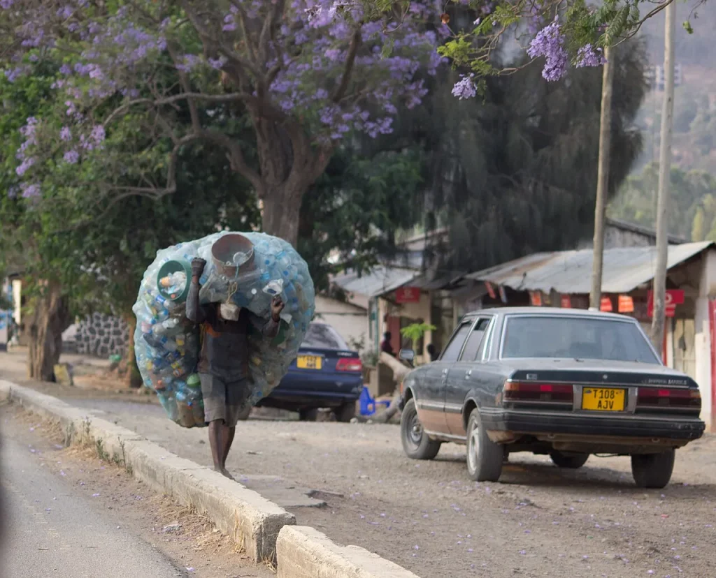 A man carrying used plastic bottles to sell to a recycling company