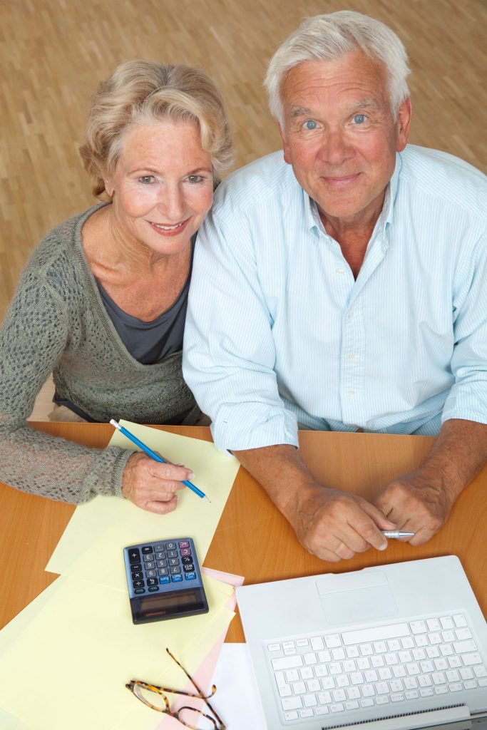 A senior couple reviewing paperwork together at a table
