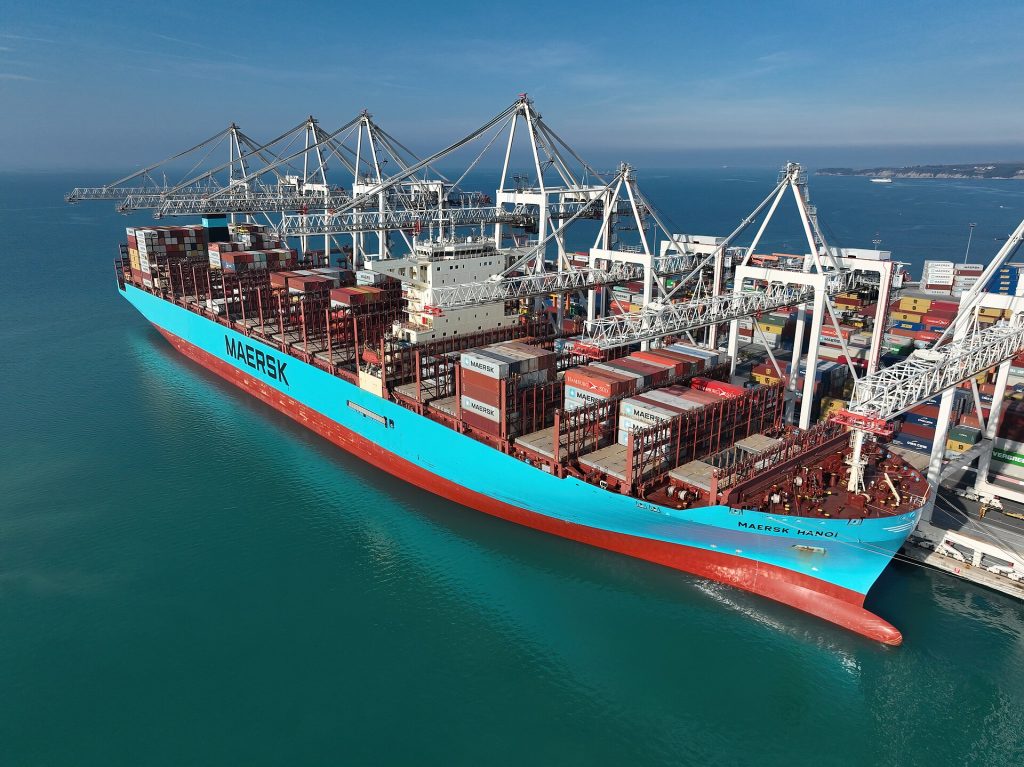 A large container ship in port as shipping lines invest in greener fuels and pass on higher freight costs.