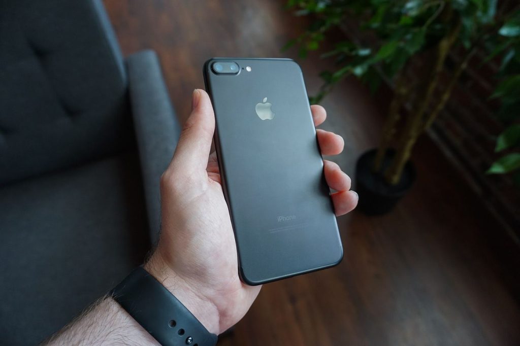 A hand holding an older smartphone being given a new lease of life