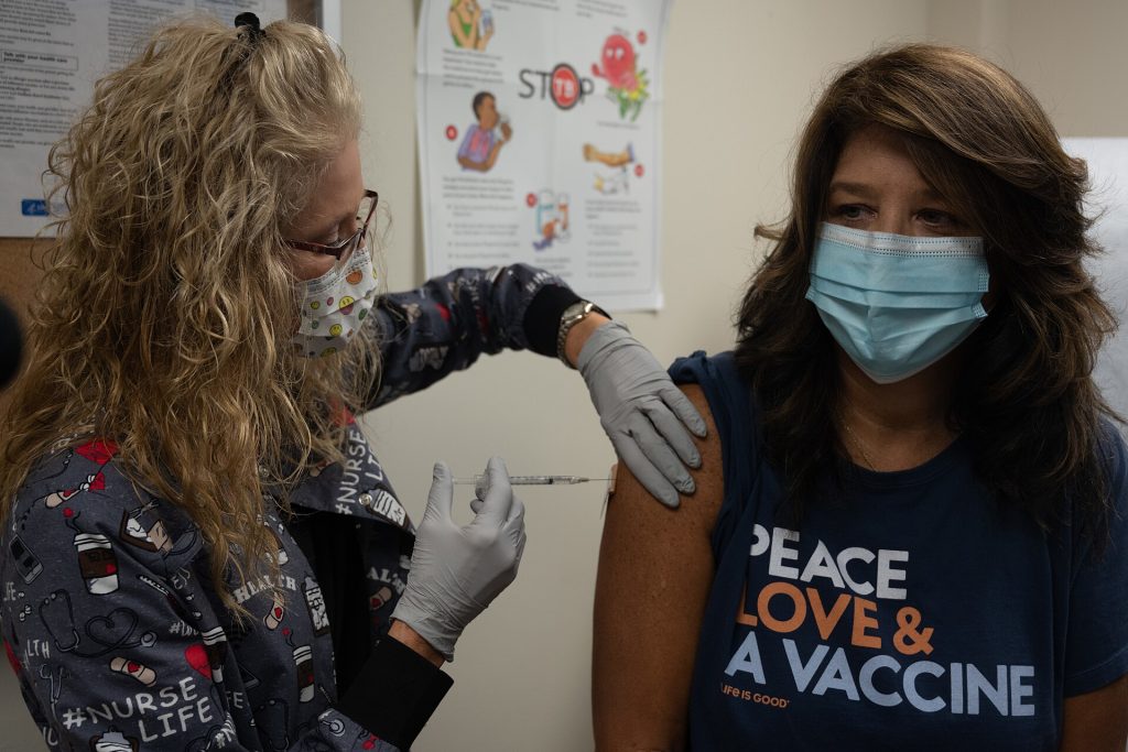 Healthcare worker preparing a measles vaccination for a patient